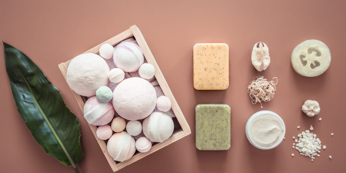 Spa composition with body care items on a colored background . Spa and body care concept . Flatlay.